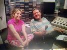 Inside a country radio broadcast studio with a mixing console and microphone